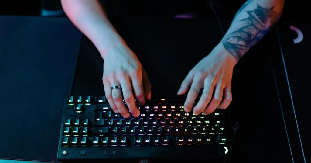 Hands typing on a gaming keyboard to enter Windows commands to fix the Roblox unexpected error crash.